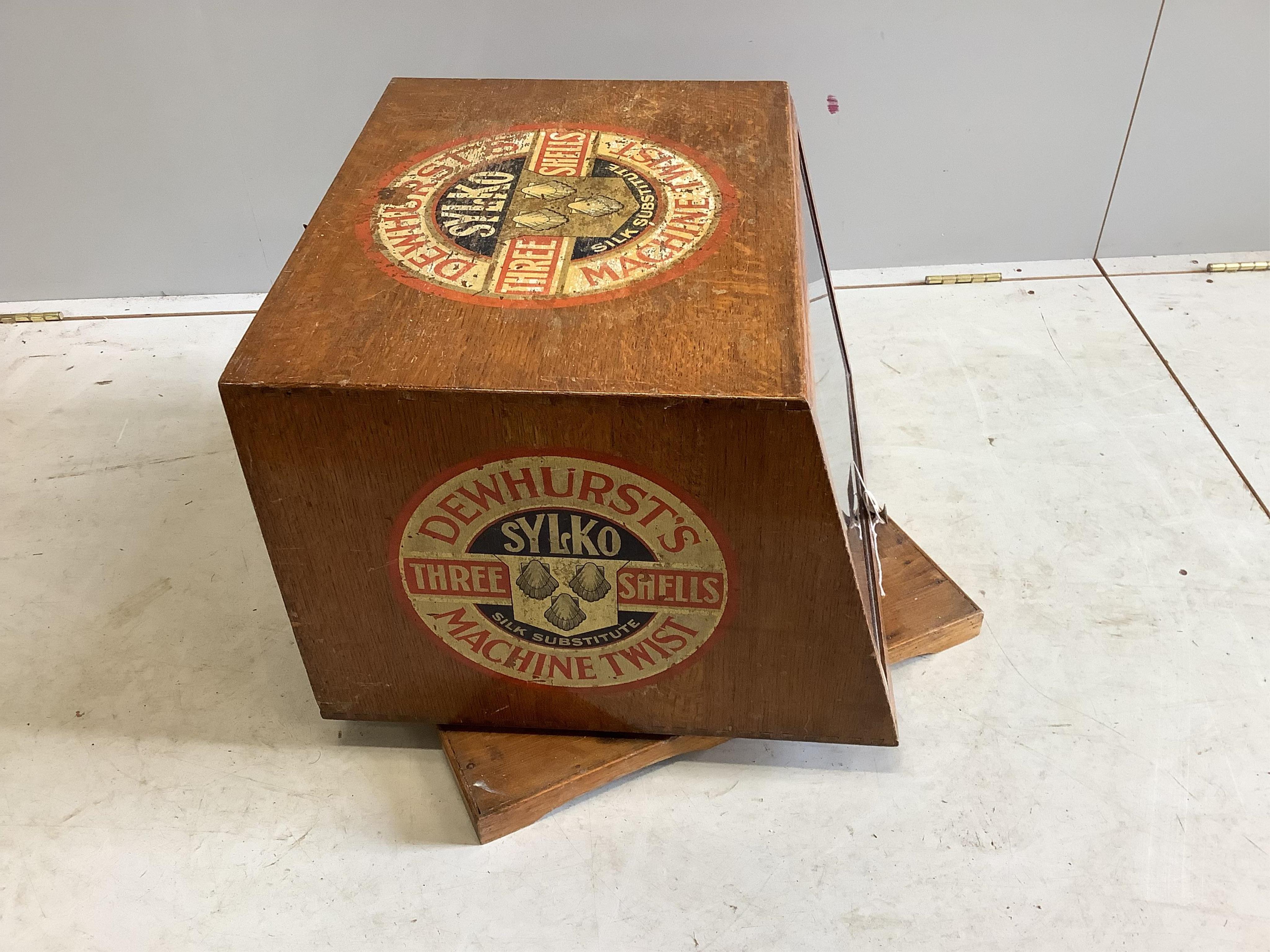 An early 20th century oak counter top display case, “Dewhurst’s Sylko Three Shells Machine Twist”, on swivel base, width 54cm, depth 52cm, height 42cm. Condition - fair